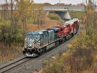 On top of the escarpment it is snowing and CEFX 1047 is showing some on the nose, but down in the Hamilton basin it is pouring rain. The daily CP 246, running rather early, slowly makes its way down the hill on its way to Kinnear Yard.