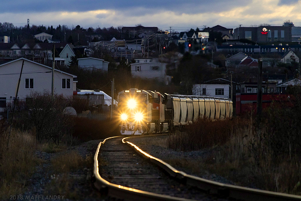After setting off the first half of their train, CN B730 has returned to their second half, still at CN's Island Yard, in Saint John. They are seen here rounding Cains Corner, "the rock cut", heading to Courtnay Bay. Some great track along this spot, but it could be over emphasized by the 250mm lens.