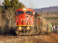 IC 2458, in CN paint, leads train 406 approaching Passekeag, New Brunswick with a wave from the engineer. 