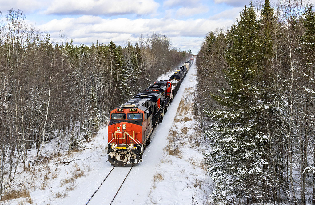 After a fresh snowfall, CN 2338 is westbound, as they approach Petitcodiac, New Brunswick.