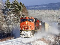 In a winter wonderland, train 406 hustles along the Sussex Sub, approaching Passekeag, New Brunswick. 