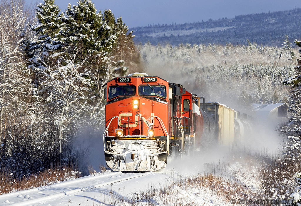 In a winter wonderland, train 406 hustles along the Sussex Sub, approaching Passekeag, New Brunswick.