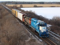 CN local 551 is seen heading back towards Aldershot as it departs Milton with three cars in tow after meeting train 422 with a couple of dimensional loads. The centre beam will be left at Tamarack Lumber in Burlington on its way back. Lead unit GMTX GP38 2254 is wearing similar colours to those it wore while working for the GTW so many years ago as GTW 5810, and is seen once again working for its old parent company Canadian National. 