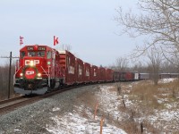 With shows at both Milton and Hamilton behind them. The annual CP "Holiday Train" (American Train) is rolling westward towards its first show of the day at Galt. Train 246 is holding on the main up ahead at Puslinch as the "Holiday Train"prepares to take the siding briefly before continuing on. The sweeping curve here at Victoria Road allows the whole train to fill the frame. A few spectators have taken to the hill in the background to take in the festive view. 