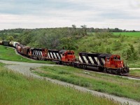 3 ex NAR SD-38's lead CN's Winnipeg to Elgin Manitoba out of the Pelican Lake Valley west of Ninette Manitoba on a line built by the Northern Pacific in 1889 to break CPR's prairie monopoly and later incorporated into Canadian Northern in 1899