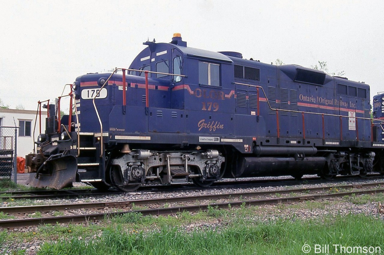 OLOR GP9 179 "Griffin" is shown with sister unit 180 "Champlain" at Vankleek Hill on May 22nd, 2000. OLOR is the Ontario L'Orignal Railway that was operated by RailTex/RailAmerica, and L'Orignal (note the spelling, not L'Original) is on the Ottawa River 88kms east of Ottawa. The line was acquired by Quebec Railway Corp in 2000.

Both 179 and 180 were ex-Cartier GP9's that came to OLOR via the GEXR in the 1990's, and later made their way to the Michigan Shore Railway (where both ran until eventually being sold for scrap).