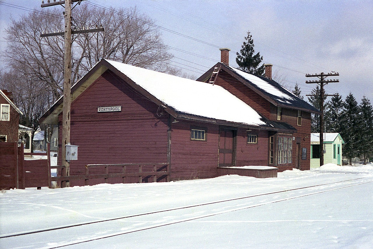Here is a closeup of the old Pontypool CP station, and then new 'passenger shelter' situated on the left side of the track as outlined in my previous submission showing the area and the grain elevator landmark. Strictly for the station fans, this is, and I felt fortunate that the sun happened out after a long drive just to get to this location what featured on and off snow most of the way.
The station was to be demolished (it looks rather drafty!) in the New Year but I understand just the freight part of it was torn down and some use was going to be made out of the rest of it. That part did last into at least mid summer 1977.  Anyone have information on it?
The line, Havelock to Toronto, back then was served daily, I believe, but CP Buddcars; but now it is a freight only line, served by an internal CP shortline, the Kawartha Lakes Railway.