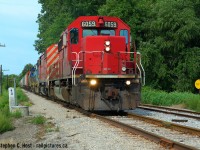 CSX Sarnia-Chatham train D725 is southbound out of Wallaceburg with 93 cars, and I'm standing at SNS Wallaceburg, which is the sign facing the tracks (CP Style) at the Mile 40 concrete milepost and was the only really useable siding to meet trains in the latter years, at 5343 feet in length.  CP 6059 typical of the junk assigned by CP to run-through on CSX to Sarnia,  CP would take it as (524/525) from Detroit to Chatham and CSX Sarnia crews the rest of the way. What I don't know is if this train used CP power from the US originating terminal (Toldeo?) or only from Detroit. The two CSX units were left in Chatham for the D724 later that afternoon (1400 Tues/Thurs Blenheim turn). Corrections welcome - that Slow sign is what attracted me to this spot... an interesting detail for the modeller types.
<br><br>All of this is essentially abandoned now, not sure if it's still in place - Chatham Kent had the line for sale for scrap or operation last I checked.... and was paying about $50k to maintain all the infrastructure per year with no trains..
