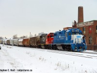 Here's the only train to be found with CN paint on the first day of CN's operations on the Guelph sub in 20 years, seen passing the Rumpel Felt Company building just west of the Kitchener station.
<br><br>
The way I see it, last trains and first trains run whenever they do, despite the weather. And I heard there was a flurry of activity at Kitchener just before Lunch so off to Kitchener I went to capture some shots (anything!) of the first day of CN's return to the area. Ultimately, today was a day of learning for everyone, new rules, timetables, signal testing between MX and CN at Sturm (new control point mile 65.1) and all kinds of delays. I'll try to tell some of the stories as I heard over radio and saw with my own eyes.<br><br>
L540 was sent down the Huron Park Spur to work the Interchange and was set to meet L568 in the yard at Kitchener so some of these cars can be taken to Stratford. Metrolinx sent their Geometry truck down the line and took the Kitchener siding out of service completely, and at the time of this photo the Truck (As a foreman) was in Guelph heading east. Due to the way MX CTC or the TOP was set up 540 could not get any light until the truck was clear Hanlon, delaying 540 so I was able to make it here for a shot. L568 was patiently waiting in the yard, and at the same time A432 was on duty at the east end of Kitchener yard with QGRY 2008 and SLR 3806 looking to depart with about 60 cars. 568 wanted to go first but the Trainmaster wanted nothing to do with that. With 540 having the main track (Kitchener to Hanlon, remember, MX CTC is primitive!) 432 was going nowhere until 540 cleared, 568 got a clearance and departed for Stratford, and by then I had already went back to Guelph with a couple shots of this train, the only train with CN painted power to be found in daylight. 432 would depart around 2:30 PM with only the GEXR assigned motive power! To top it off 85 was delayed about 45 minutes due to signal issues at STURM and even called the CN RTC to note errors in the timetable/DOB and confirm speed limits. It's certainly been an interesting week. Corrections welcome of course.