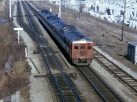 This is about as old as they get in my personal collection. Early 1974. Here's the CN Budds as witnessed from Waterdown Rd bridge, back in the day when one could stand there and not be driven mad by vehicle traffic. It was actually rather quiet. To the left of the big overhead signal structure is where more track and the Aldershot GO station are located today. I like this shot for the massive storage of concrete blocks, all part of the old J.Cooke Concrete Blocks Ltd that used to be located here. Don't know why they left or where they went. 
This scene is an interesting one to recall the next time you drive over the CN mainline out in Aldershot. Time machine, anyone?