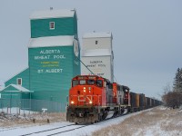 CN SD40-2Ws 5325 and 5279 had their work cut out for them last night, hauling 74 loaded gravel cars from Whitecourt into Edmonton. Here, they're seen passing the grain elevators at Mile 5 of the Sangudo Sub, St. Albert.