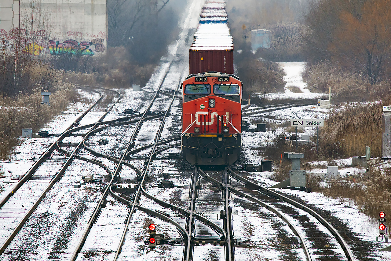 2330 is the third unit in another enormous CN stack train passing through the maze of Snider en-route to Western Canada ( a guess based only on time of day)