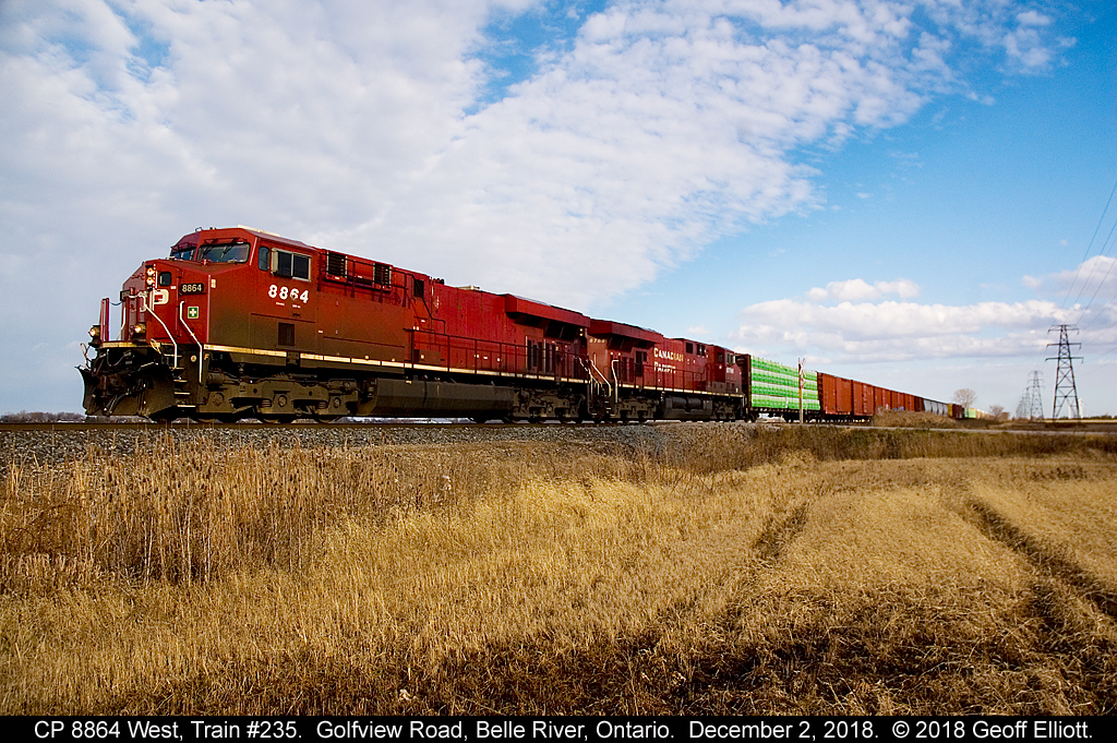I like to call this shot "Shootin' Blanks"....  Of all the CP units to catch on the point of a train, Beavers, Dual Flag, plain Canadian Pacific, I had to catch one of the few with NOTHING on it's flanks......  CP 8864 West crosses Golfview Road just east of Belle River, Ontario on December 2, 2018.