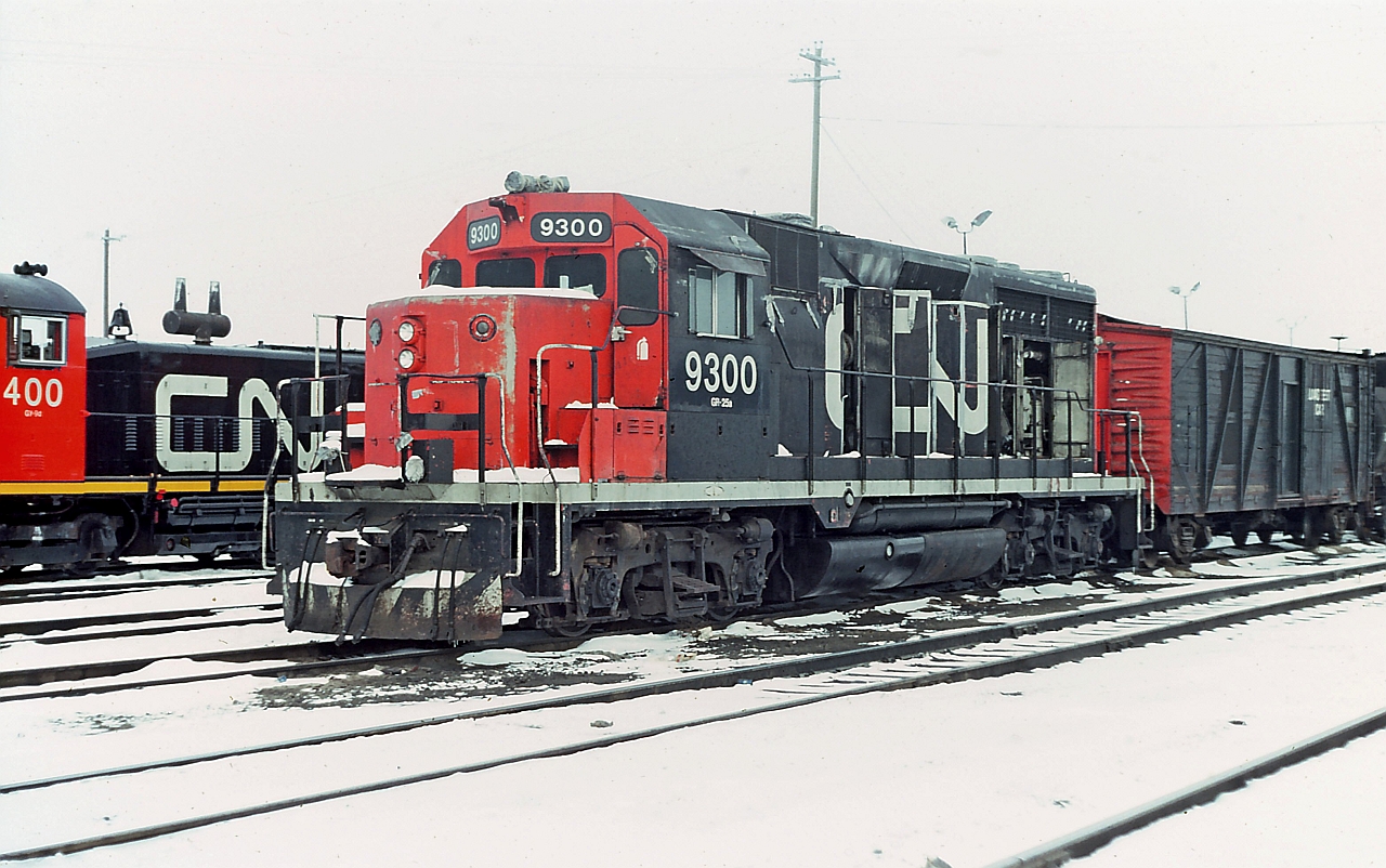 CN 9300 at the Calder diesel shop in Edmonton, Alberta. I believe this is one of two GP35's that CN had and was originally numbered 4000. Anyhow, on this winter afternoon I had done a quick sweep through the shop area on the way to work and found this unit there. It was dead and drained, whistle and exhaust stack taped and capped, bell missing and obviously not in service. Really don't know the disposition of the 9300 and why it was there. I can't recall if I took an image or two of the old wooden boxcar and tank behind the unit, never know what I might find in a dusty yellow slide box.
