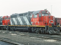 CN 9301 and 9300 on the shop track at Calder Yard, now known as Walker Yard. Bell and classification lights missing on the 9301 as well as being dead and drained, obviously not fit for service. My info is that the 9301 was originally numbered CN 4001 and one of two GP35's that CN had. Any info about these units greatly appreciated.