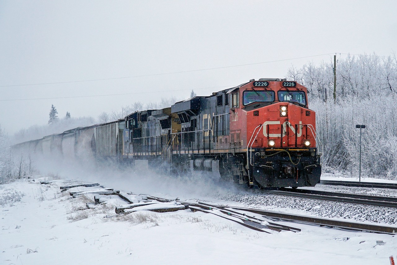 CN 2226 and GECX 7785 have a clear road east at Lindbrook throwing up the fresh snow as they pass.