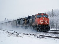 CN 2226 and GECX 7785 have a clear road east at Lindbrook throwing up the fresh snow as they pass.