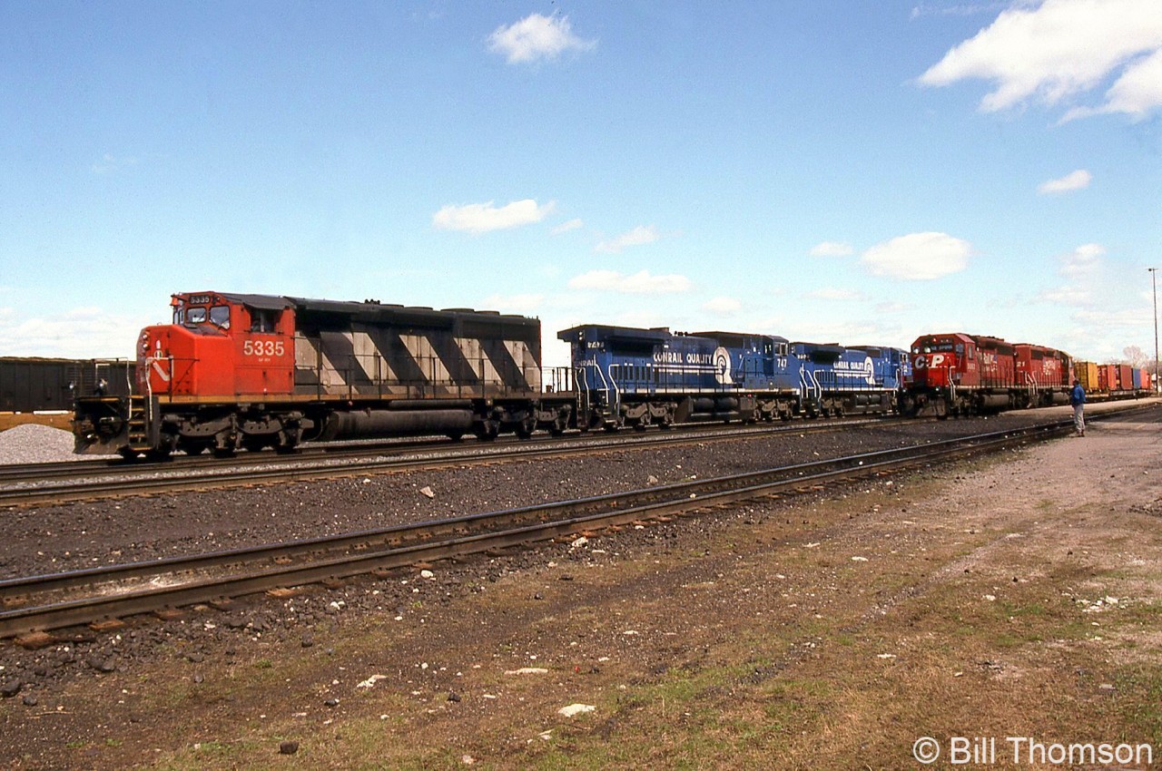 In this view, a detouring CN freight on CP at Smiths Falls is pictured pulling out of the station past a nearby CP freight at the station, with CN SD40-2W 5335 leading leased Conrail C40-8W units 747, 752 and 748. For a photo of the trailing units: http://www.railpictures.ca/?attachment_id=35537.