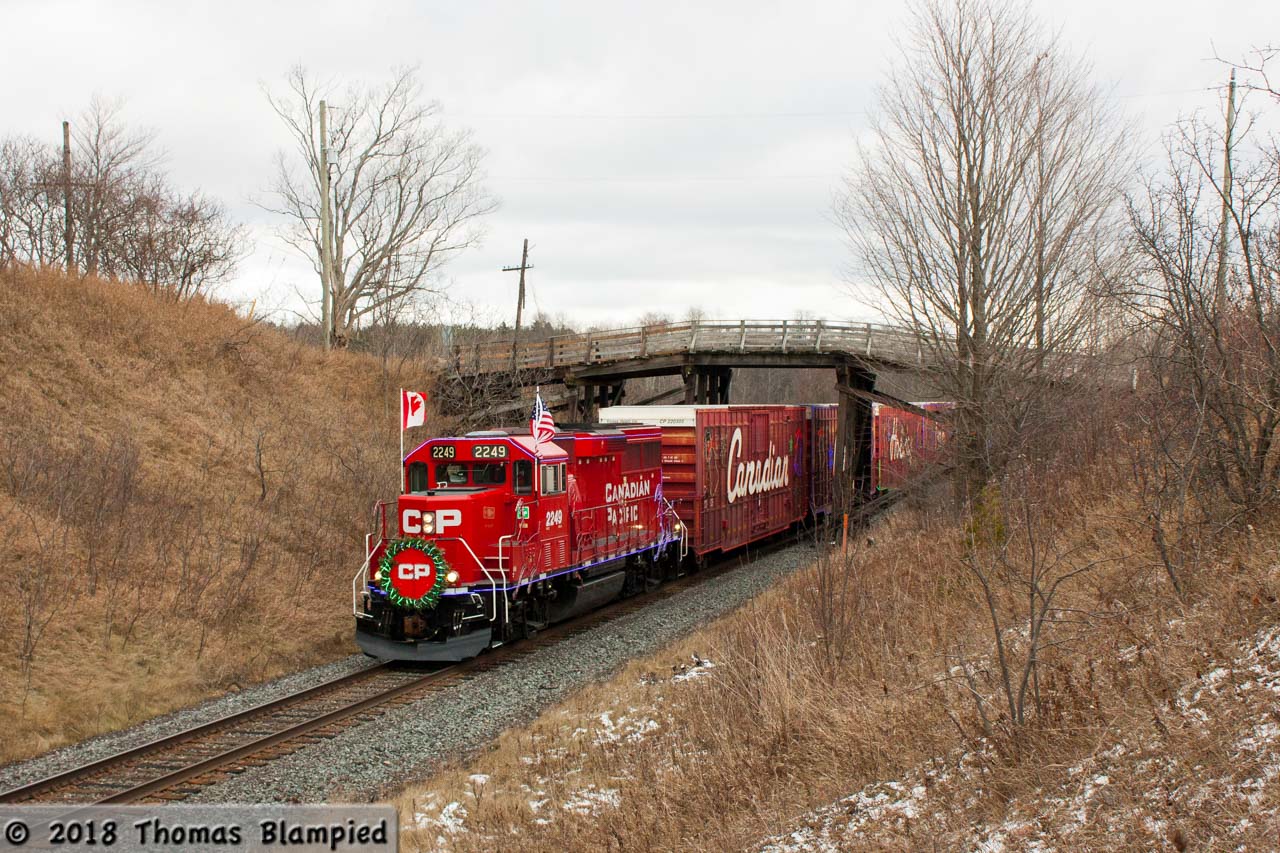 Nothing says the CP Holiday Train quite like snow and nighttime photography or, if you're east of Toronto, yellow grass and a cloudy afternoon. Nevertheless, the train injects some much-needed colour into the late fall gloom. Despite being closed to vehicular traffic, the wooden bridge still spans the track as the 20th anniversary Holiday Train rolls west towards its next stop in Bowmanville.