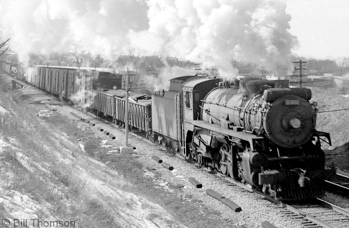 CPR P2f-class 2-8-2 Mikado 5402 heads a freight eastbound through Cooksville on the Galt Sub in 1958.