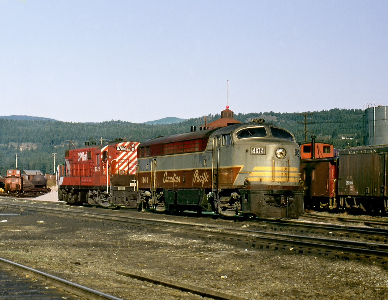 During the era of FM power in the Kootenay's, a C-Liner and an H-Liner sit on the roundhouse lead in front of the station