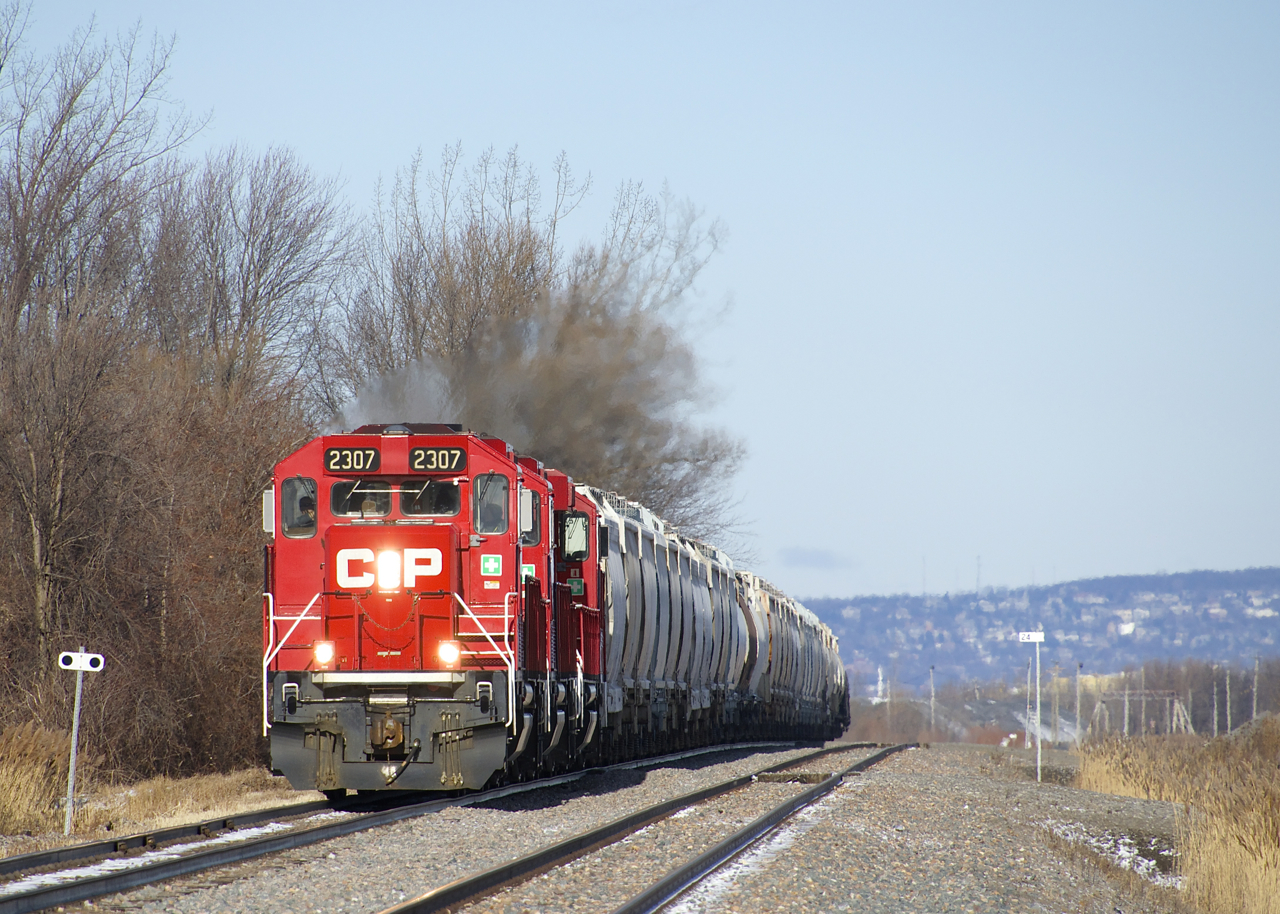 With Mount Royal in the background, CP F94 is passing the St-Mathieu siding, where it will set off its cement cars before heading south to Napierville with two tank cars. Power is a trio of GP20C-ECO's (CP 2307, CP 2253 & CP 2257).