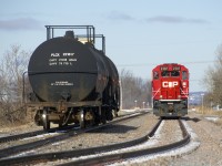 After shuffling cement cars For LaFarge and shoving them into the St-Mathieu siding, CP F94's light power heads through the siding so it can back onto the two tank cars that it will take to Napierville.