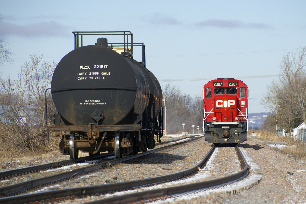 After shuffling cement cars For LaFarge and shoving them into the St-Mathieu siding, CP F94's light power heads through the siding so it can back onto the two tank cars that it will take to Napierville.