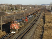 CN 2427 & CN 2554 lead a 75-car CN X321 westbound through Pointe-Claire on the Kingston Sub. The train is composed almost entirely of gons loaded with steel products, with about a dozen tank cars at the rear.