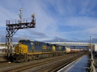 CN 327 with ES44AH's CSXT 3123 & CSXT 915 passes underneath a signal gantry at Dorval.