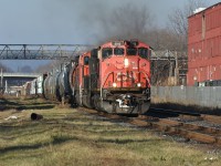 CN A421 has a faded NA scheme C44-9WL lead the way on the hot track as it leaves Hamilton