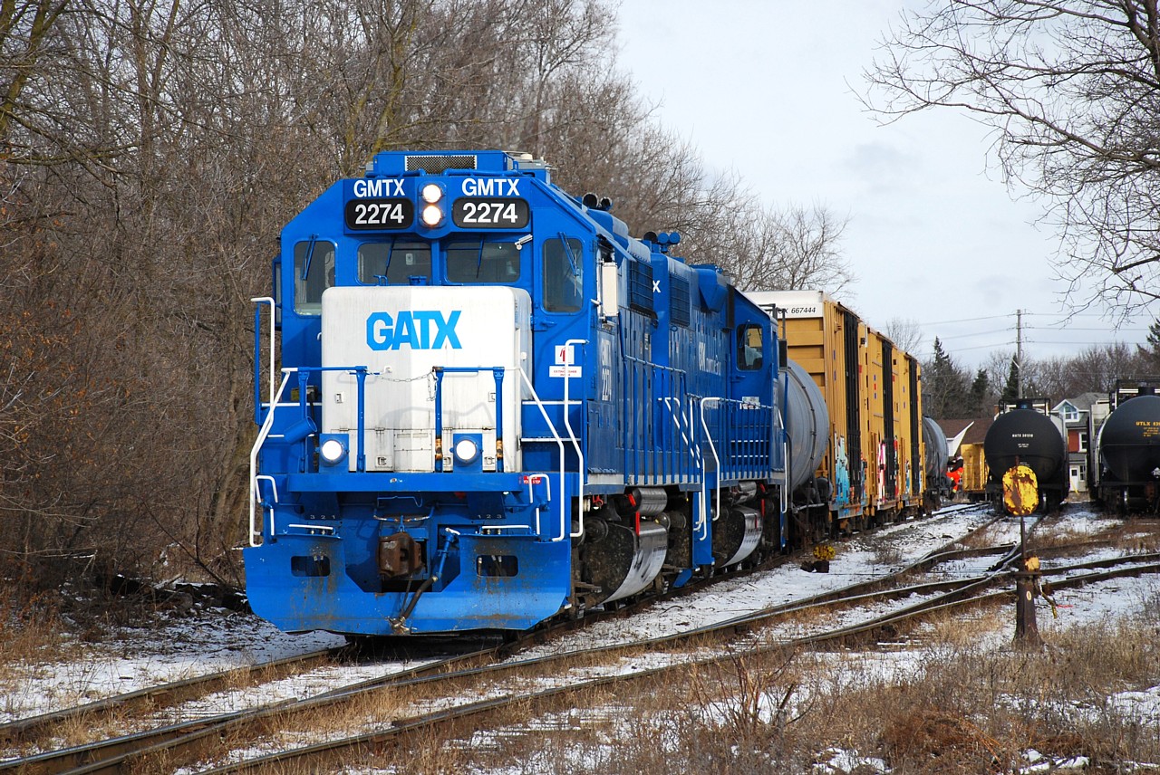CN L542 with GMTX 2274 and GMTX 2289 switch the small yard at Guelph Jct. on the former Fergus Subdivision.  After completing their switching here they'll head north to the industrial spurs and do some more switching in coordination with the Ontario Southland Railway.