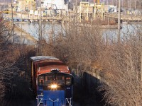 After dropping four loaded box cars at WP Warehousing on the north side of the CN Grimsby Sub, Trillium brings the empties up the hill on the Thorold Sub/Spur with leased power GMTX 340. This recognizable location, made famous by the steep grade and the Welland canals twin flight locks as a backdrop have been captured a number of times by other Railpictures photographers including <a href="http://www.railpictures.ca/upload/it-was-indeed-a-surprise-when-waiting-for-ns-328-autoparts-train-at-merritton-to-witness-them-stop-and-the-switch-thrown-at-mile-9-49-and-the-train-lined-for-the-thorold-sub-what-the-emergenc">Arnold Mooney</a>, <a href="http://www.railpictures.ca/upload/trillium-railway-110-an-ex-cn-mlw-s13-throttles-up-to-climb-the-grade-on-the-former-cn-thorold-subdivision-with-their-short-lived-diner-train-i-believe-that-the-passenger-cars-went-back-to-the-ne">Geoff Elliott</a> and <a href="http://www.railpictures.ca/?attachment_id=33285">Doctapinklaces</a>. 