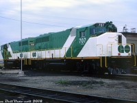 Freshly minted GO Transit GP40-2W's 707 and 708, recent graduates of GMD's London Ontario locomotive plant, sit at CN's London Yard awaiting forwarding to their new owner. They were the first two units of GO's third -2W order being built (707-710, all shown as built October 1975) and were the only group delivered new with 700-series numbers, unlike earlier orders that came as 9800's (renumbered to 700-706).<br><br>Rather than opt for steam-generator equipped units as they did with their GP40TC order, GO Transit in the 70's opted to expand its fleet with the standard freight-service GP40-2 model equipped with 76mph (60:17) gearing and the new CN-designed Canadian Safety Cab (note: officially there was no "W" in the designation, it was added by railfans). HEP-equipped cab cars rebuilt from old Ontario Northland F-units would be used with the freight GP's to provide electrical power for the passenger cars. It's interesting to note that GO Transit was the first buyer of the GP40-2 model equipped with the safety cab: GO 700-703 were ordered in December 1973 and built in January 1974, just before CN's first order of 9400's were built beginning in March 1974. However, by that time CN had already taken delivery of GP38-2W 5560 (4760) and 3500-series MLW M420's with the new cab design earlier on in 1973. <br><br>GO 707, 708, and all but one of their sister units would eventually be displaced by new F59PH's and join the CN fleet in 1991, becoming 9674 and 9675 respectively.<br><br><i>Gord Taylor photo, Dan Dell'Unto collection.</i>
