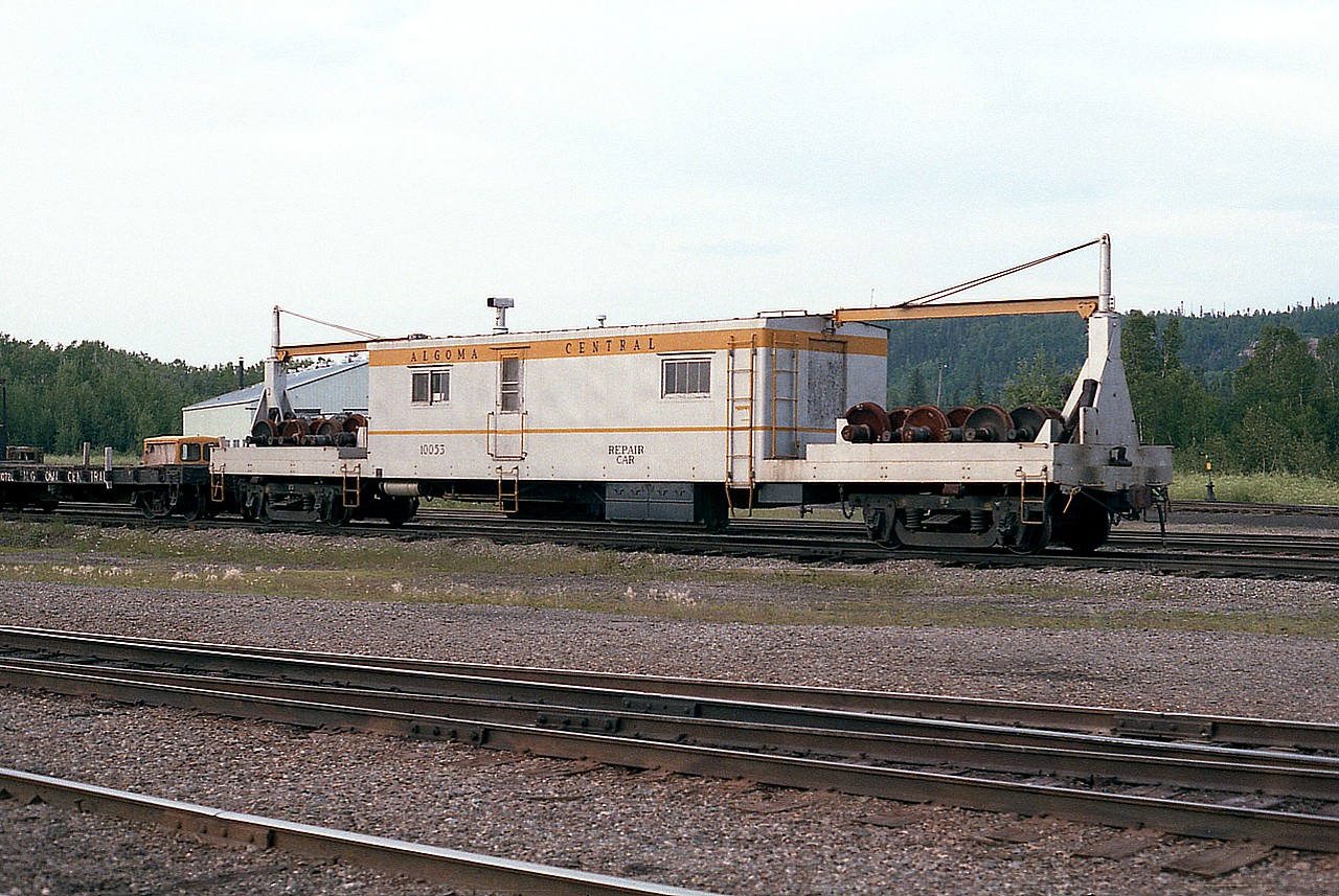 Algoma Central Repair Car #10053 sitting in the Hawk Junction yard. In behind can be seen the enginehouse. I have no history on this piece of equipment. Wondering if it still exists.