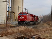 The price of progress. With all the recent upgrades to the Galt subdivision, including the future activation of the new signals through Streetsville, it appears that the old ADM Mill will not see any service, anytime soon. Several weeks ago the connecting track along with the two switches were removed, the ties are still in the ground for now. The spur still remains intact beyond the curve in the background. Its hard to believe that about a decade ago ADM received daily service, often twice on Wednesdays. Today local T14 only switches Streetsville on Monday, Wednesday and Friday's, and the Ardent Mill off to the left is usually only served once a week or as needed. There are no cars at the mill today. A far cry from years gone by when both Reid's Mill and ADM were the main customers in town. Here we see rebuilt 8059 heading Hamilton bound as it passes the discarded remains of a portion of the old ADM spur.