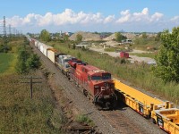 With afternoon thunderstorms firing up to the west, CP 140 meets CP 235 with new wellcars from National Steel Car at East Walkerville. A Kansas City Southern de México AC4400CW in the original grey ghost paint was trailing. The skylines of Windsor and Detroit are visible in the background from this overpass. 