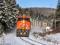 CN stack train Q120 rounds the bend at Folly Lake, Nova Scotia, in a nice Winter scene.