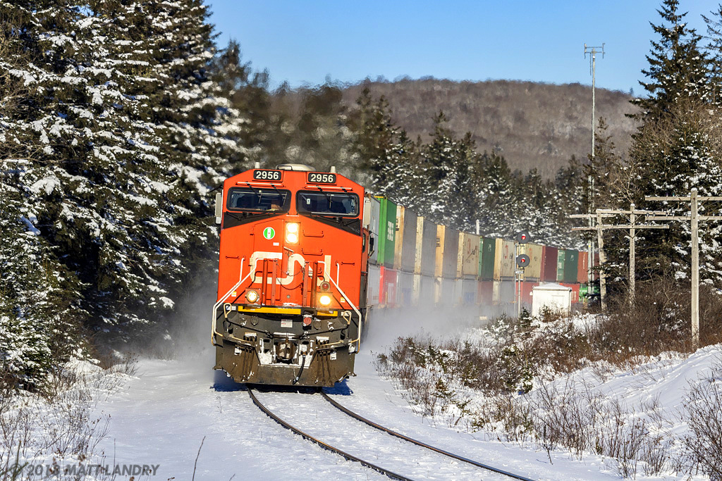 CN stack train Q120 rounds the bend at Folly Lake, Nova Scotia, in a nice Winter scene.