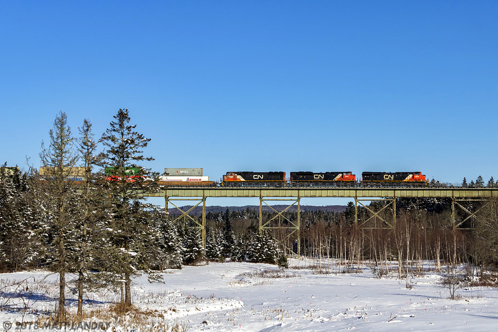 CN Q120 crosses over the trestle at East Mines, Nova Scotia. They will meet westbound train 407 at the siding at Belmont, about 8 miles from here, just west of Truro, Nova Scotia.