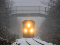 CN 5749 leads train 406 approaching mile 75, cresting the hill at Quispamsis, NB during a snowstorm. 