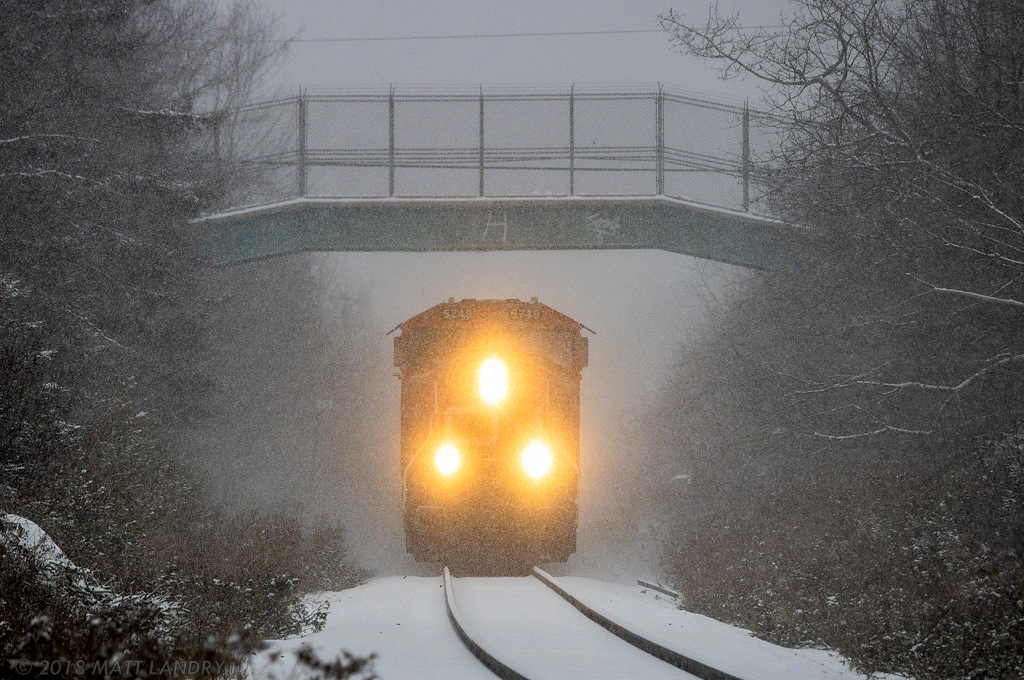 CN 5749 leads train 406 approaching mile 75, cresting the hill at Quispamsis, NB during a snowstorm.