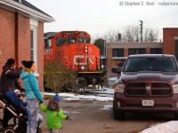 Peekaboo: A family marvels at the rare sight of a train along Crimea St in Guelph, 4777 plays peekaboo behind a house where the rails are mere feet to the cornerstone of the property. This track is the wye of the Guelph N Spur and has been like this for well over 70 years, the houses and factories dating to the 1940's at least if not older. This was taken across the tracks and behind <a href=http://www.railpictures.ca/?attachment_id=35603 target=_blank> Kevin Flood's shot </a> taken a couple days earlier.