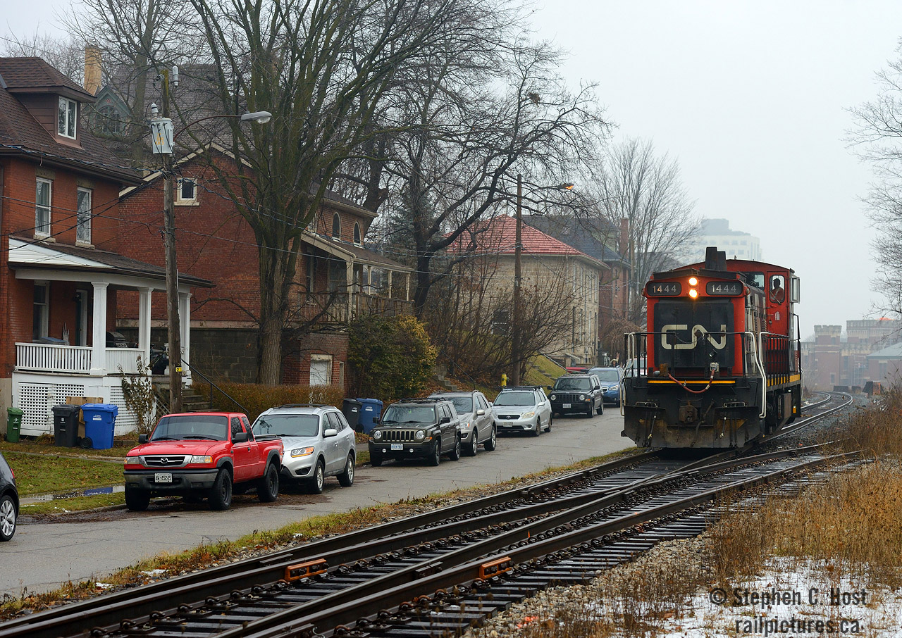 Caption: Kevin's recent shot of L566 parked on the Waterloo spur, had consequences for the rest of the Guelph sub as now the Kitchener terminal would be quite short of motive power. To ensure two jobs operated the GMTX units (2) were assigned to 568 and L540 took this as their sole motive power to putter around between Kitchener, Guelph, Acton, and back. Returning from Canwel in Acton light power I took the opportunity to photograph 1444 passing Guelph's famous beside-street running at Kent St. In the far background are some of Guelph's landmarks - the Armoury an active yet historic 1906 DND facility and the new River House condos. A GMD1 on the Guelph sub in 2018? Pinch me.