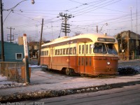 Long Fall evening shadows are cast on TTC PCC 4522, operating on the Rogers Road route about to depart Bicknell Loop and head back east. The Rogers Road streetcar route ran from Oakwood Loop (or St. Clair Subway Station during rush hours) north on Oakwood Ave., west on Rogers and looped here at Bicknell Loop at the NW corner of Rogers & Bicknell, across from a Dominion grocery store and their large distribution warehouse (that had a rail siding off the CP MacTier Sub, and was once home to munitions manufacturer York Arsenals during WW2). The 4500-series A8 PCC streetcars, the newest in the fleet at the time, were commonly assigned as the Rogers route was operated out of Wychwood (St. Clair) Carhouse. <br><br> By this point in time, long shadows were also cast over the existence of the Rogers Road streetcar itself, and less than a year's time it would cease to exist altogether. Part of the reason (noted in Sean Marshall's <a href=http://spacing.ca/toronto/2014/07/19/remembering-rogers-road-streetcar/><b>Spacing.ca post on the route</b></a>) was the town of York didn't want to spend the extra money including new streetcar track when repaving some of its deteriorating roads (looking at photos taken during the final days, parts of Rogers Rd. were looking quite shabby), and part of the reason was after reversing its decision to phase out all streetcars over the next few years, the TTC was short of streetcar equipment to operate its routes until new cars could be designed, ordered and built. Thus, the final day of streetcar services on Rogers Rd. was July 19th 1974, followed by replacement with with a branch of the Ossington trolleybus route. <br><br> <i>Original photographer unknown, Dan Dell'Unto collection slide.</i>