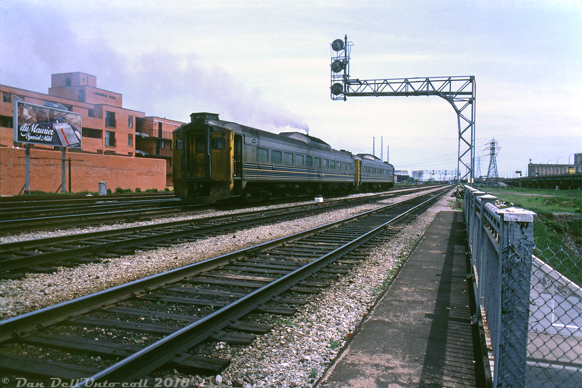 VIA RDC-1 6109 trails a sister RDC operating on train #652 as they depart downtown Toronto in a cloud of Detroit Diesel exhaust, heading eastbound over the Lower Jarvis St. rail viaduct and past the Crombie Park apartments. According to period timetables, #652 "The Ontarian" was a daily (except Saturday) Toronto-Kingston run departing 13:00 from Toronto's Union Station. One of the many runs still handled by Budd RDC's or "Railiners" (in CN parlance) at the time.

VIA 6109 was one of many RDC's purchased secondhand by CN: originally built for the Chicago & Eastern Illinois as their "RDC-1", and purchased by CN in 1964. After serving for VIA, 6109 was sold to Ferrocarriles de Cuba with a few others in 1998.

Charles O. Begg photo, Dan Dell'Unto collection.