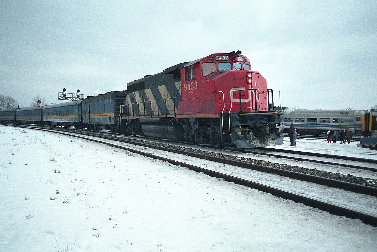 Quite often in days past I would get the opportunity to shoot what amounts to an unusual scene. And usually I do not get an explanation as to what I am photographing. And even when I do, I think I will remember, and of course, don't.  This image is a good example. The westbound passenger cannot be #77 because it would be dark out. The timetable shows #75 as an 'express' train right now, and it too would be under darkness as this image was shot before sundown and it is New Years' Eve, 1985. So perhaps this is train #83 and the afternoon Budds from Niagara meeting at Bayview. First, we have a widecab pressed into passenger service. This was common for awhile. But never did I see a passenger train stop at Bayview, exchange passengers with the Budds out of Niagara. Were the Budds late for the meet in Burlington? Did someone forget to hold the westbound so passengers to London and west could transfer? What should have in my mind been a smooth transfer from one train to another ended up being a fair group of people having trudge thru the snow on what was NOT a warm afternoon. Bet there were some tempers warming up the air though.  Interesting scene. Happy New Year 1986. :o)