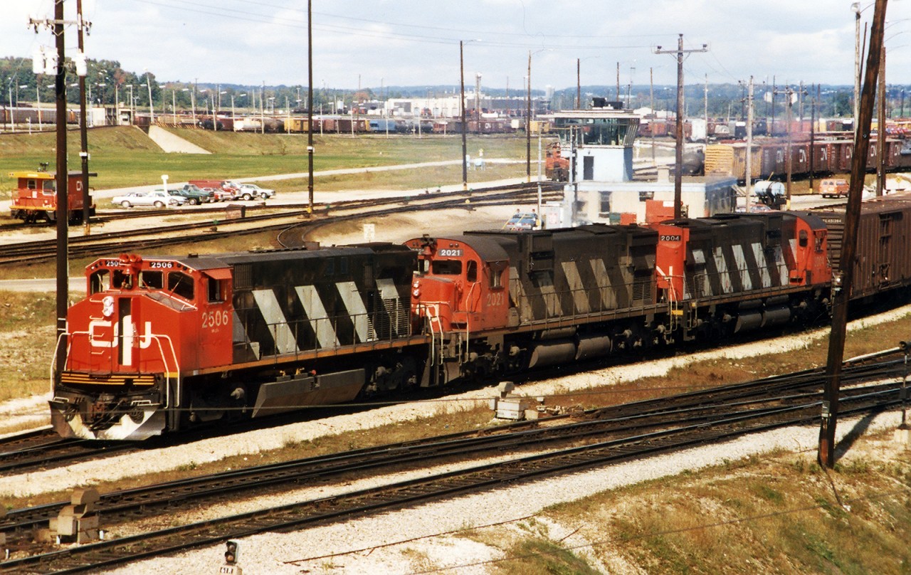 Back in the day, during certain seasons; I believe this was grapes for some reason. the outbound 392 would sit and wait for the inbound, a crew would grab the van, and the outbound train would grab the Pacific Fruit Express cars for Montreal, double on to the rest of their train an be away. Depending on the day, a South Yard crew might grab boxes for KO11 which would take those cars downt he Newmarket Sub into Toronto for distribution. On this day, M420 2506, and M630 2021, and C630 2004 pull out of the Receiving Yard and will then double over into East Control before departing for Montreal.