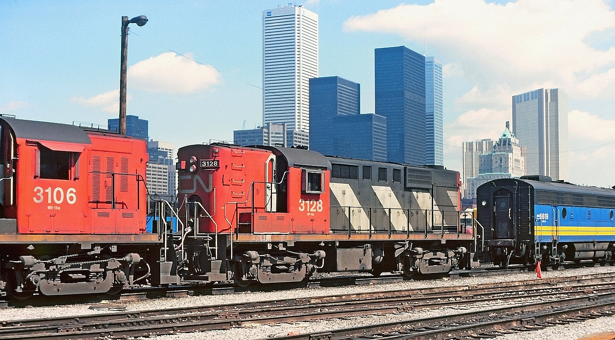CN 3128 coupled to 3106 with the 6819 further along the track.