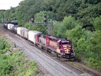 With Wisconsin Central being absorbed into CN, it was becoming increasingly difficult to see WC paint any more, so it was nice to see one on the lead of #390. Trailing unit is CN 5291. An added bonus was the WC 7638 is in Operation Lifesaver paint. 
The transformation of the area for the third track going in for GO services is apparent on the extreme left, one can just make out a construction laneway as work is under way to shore up the terrain at waters' edge.